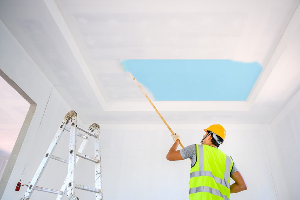 man painting in home remodel