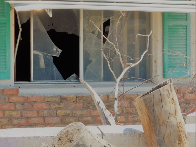 broken window from tree limb after storm damage